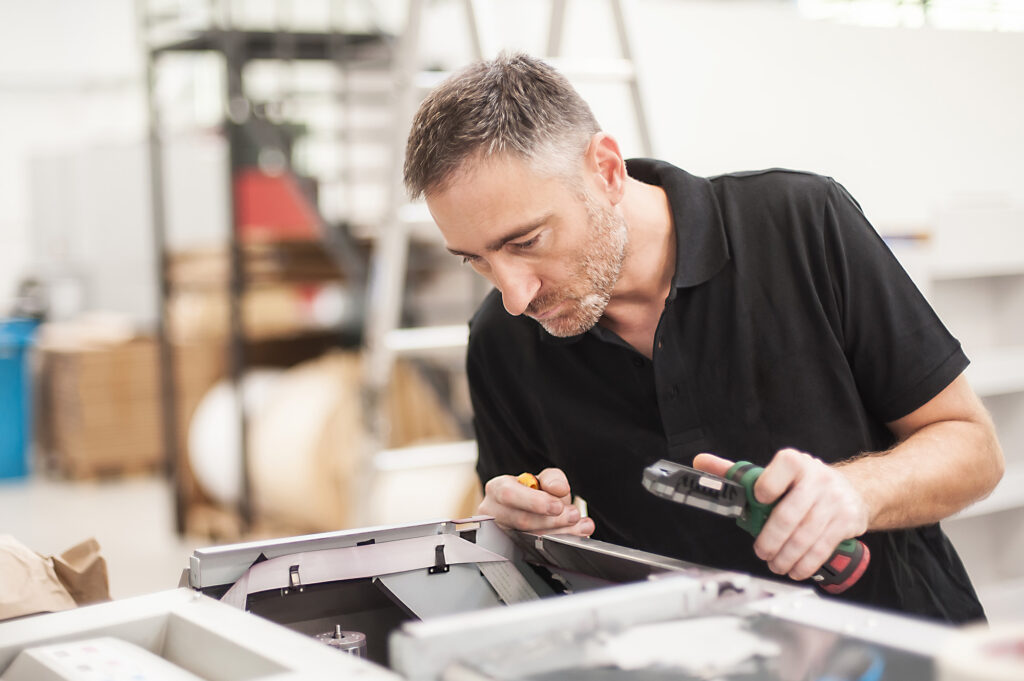 A person examining a printer