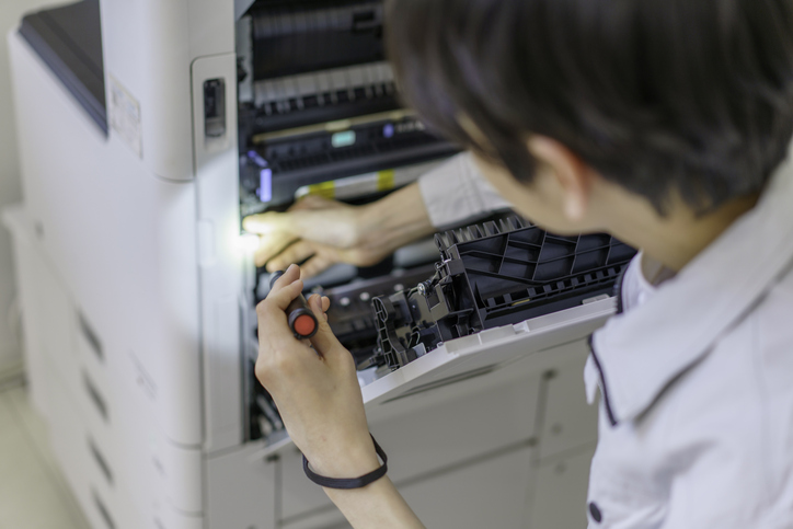 technician servicing copier office