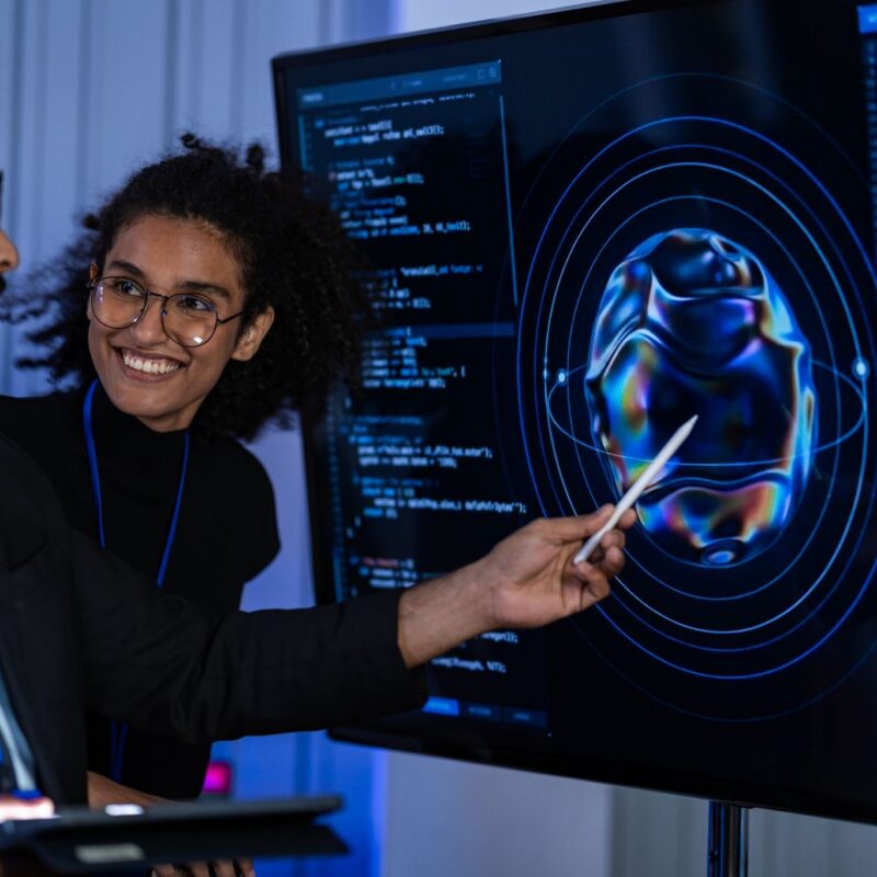 woman showing IT example on screen